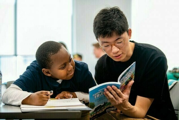 A University of Notre Dame student, right, tutors a child at the Robinson Community Learning Center. (Photo by Barbara Johnston, University of Notre Dame)